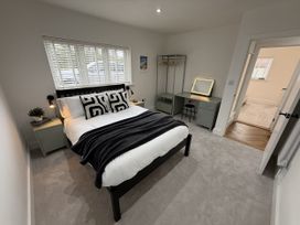 A bedroom with a bed and wardrobe at Bader House in Ipswich