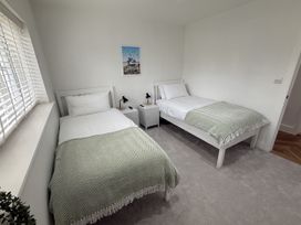 A bedroom with two beds and nightstands at Bader House in Ipswich