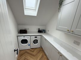 A laundry room with a washing machine and a dryer at Bader House Ipswich