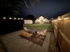 A garden with seating area and house at Bader House in Ipswich