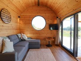 A sitting area with a sofa and a window at Bugley Pools Hideaway in Bugley near Gillingham
