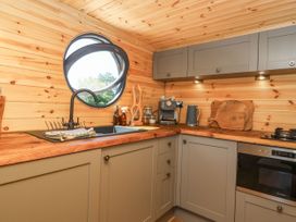 A kitchen with a sink and coffee maker at Bugley Pools Hideaway in Bugley near Gillingham