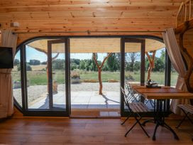 A room with sliding doors and a table at Bugley Pools Hideaway Bugley near Gillingham