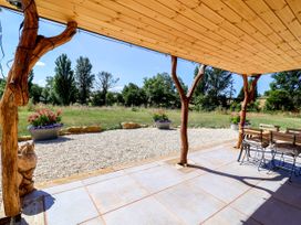 An outdoor seating area with wooden posts and planters at Bugley Pools Hideaway in Bugley near Gillingham