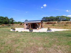 A cabin with flower pots in front at Bugley Pools Hideaway Bugley near Gillingham