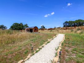 A gravel path leading to a pod-style structure at Bugley Pools Hideaway in Bugley near Gillingham