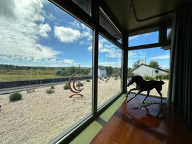 A view from a window showing a table with a sculpture and an outdoor landscape at The Garden Cottage and Carriage House Annagry, County Donegal