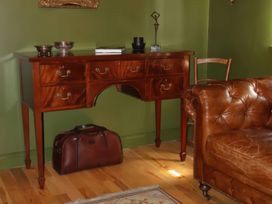 A living room with a console table and sofa at The Garden Cottage and Carriage House Annagry, County Donegal