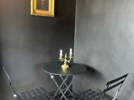 A dining area with a round table and chairs at The Garden Cottage and Carriage House, Annagry, County Donegal