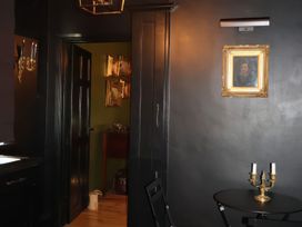 A dining room with a table and candle holder at The Garden Cottage and Carriage House Annagry, County Donegal