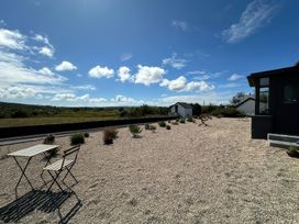 A garden area with a table and chairs at The Garden Cottage and Carriage House, Annagry, County Donegal