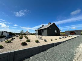 An outdoor area with a house and car at The Garden Cottage and Carriage House in Annagry, County Donegal