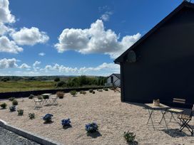 An outdoor area with gravel, table, and chairs at The Garden Cottage and Carriage House, Annagry, County Donegal