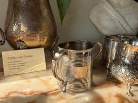 A display with silverware and a business card at Cobblestone Cottage in Ireland