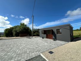 An outdoor area with a building, paved space, and plants at The Garden Cottage and Carriage House in Annagry, County Donegal
