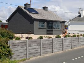 A house with solar panels and garden furniture at The Garden Cottage and Carriage House Annagry, County Donegal