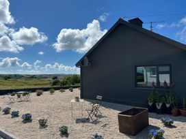 An outdoor area with table and chairs at The Garden Cottage and Carriage House Annagry, County Donegal