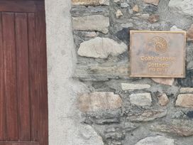 A sign for Cobblestone Cottage on a stone wall near Leabgarrow, County Donegal