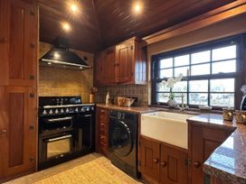 A kitchen with an oven, sink and dishwasher at Cobble Stone Cottage near Leabgarrow, County Donegal