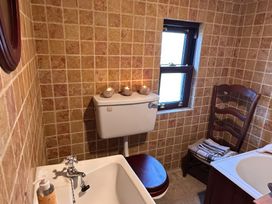 A bathroom with a sink, bathtub and toilet at Cobble Stone Cottage near Leabgarrow, County Donegal