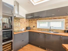A kitchen with appliances and counter space at 2 Tree Tops in Lanreath