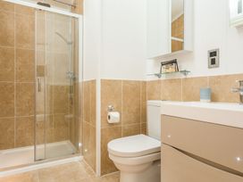 A bathroom with a shower and toilet at 2 Tree Tops, Lanreath