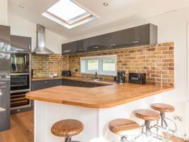 A kitchen with a sink and oven at 2 Tree Tops in Lanreath