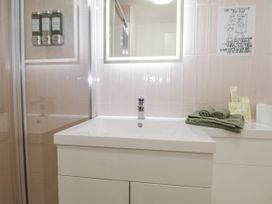 A bathroom with a sink and towels at Charltons Hollow Cabin in Haywards Heath