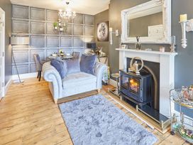 A living room with a sofa and fireplace at Apartment 2 in Whitby