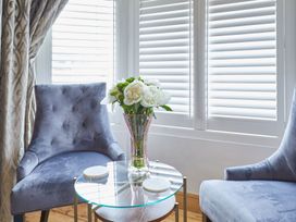 A sitting room with a vase of flowers on a table at Apartment 2 in Whitby