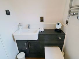 A bathroom with a sink and toilet at Bumblebee Glamping Pod, Malton