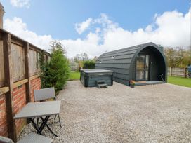 An outdoor area with a glamping pod and hot tub at Bumblebee Glamping Pod in Malton