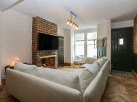 A living room with a sofa and television at 5 Llewelyn Street Conwy