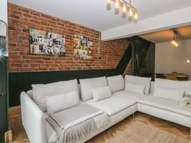 A living room with a sofa and brick wall at 5 Llewelyn Street Conwy