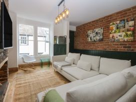 A living room with a sofa and table at 5 Llewelyn Street in Conwy