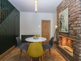 A dining room with a table and chairs at 5 Llewelyn Street Conwy