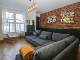 A living room with a sofa and chair at Ty Gelert in Conwy