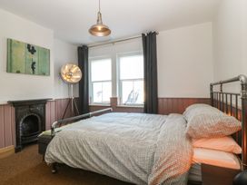 A bedroom with a bed and window at Ty Gelert in Conwy