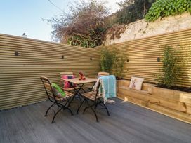 A patio with a table and chairs at Ty Gelert in Conwy
