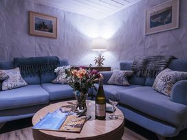 A living room with a sofa and coffee table at Tamarisk Cottage in St. Agnes