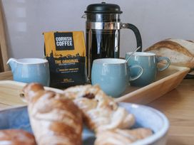 A kitchen with coffee and pastries at Tamarisk Cottage in St. Agnes
