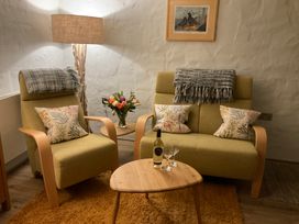 A living room with chairs and a table at Tamarisk Cottage in St Agnes