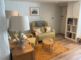 A living room with a sofa and coffee table at Tamarisk Cottage in St Agnes