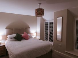 A bedroom with a bed and lamps at Bluck's cottage in St. Agnes