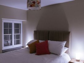 A bedroom with a bed and bedside lamp at Bluck's cottage St. Agnes