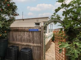 An outdoor view of Big Bertha by the Sea in Northam with a gate and mobile home