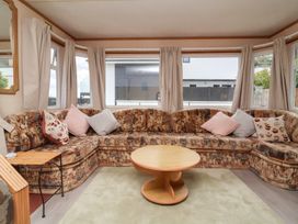 A living room with a sofa and a coffee table at Big Bertha by the Sea in Northam