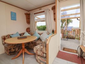A snug with a table and sofa at Big Bertha by the Sea in Northam