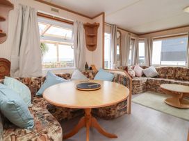 A living room with a sofa and table at Big Bertha by the Sea in Northam
