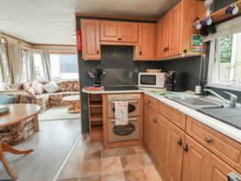 A kitchen with cabinets and appliances at Big Bertha by the Sea Northam